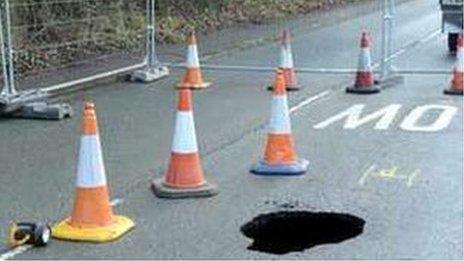 Hole in road with cones