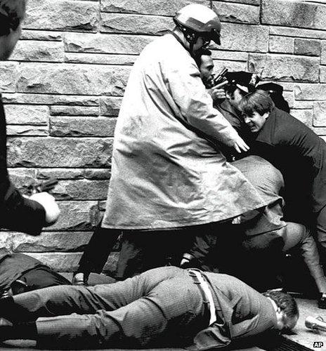 James Brady, President Reagan's press secretary, lies wounded on the sidewalk outside a Washington D.C. hotel 30 March 1981