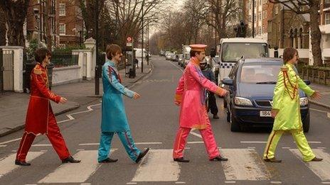 Beatles look-a-likes cross the famous zebra crossing in Abbey Road, St John's Wood, London,