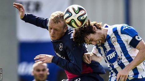 Ballinamallard's Raymond Foy in an aerial duel with Coleraine defender Howard Beverland