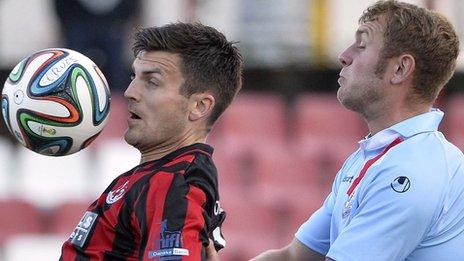 Diarmuid O'Carroll of Crusaders in action against Ballymena's Johnny Taylor