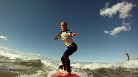 girl standing up on surf board