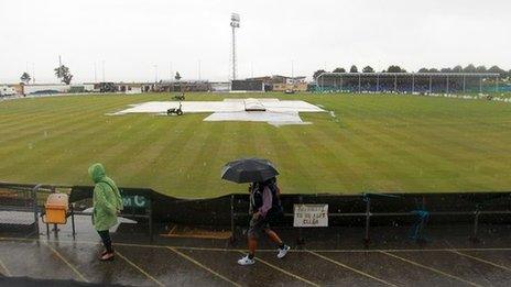 Spectators faced a bleak scene when heavy rain fell during the middle of the match