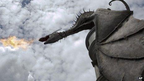 A dragon breathes fire from atop Gringnotts Bank during a preview of Diagon Alley at the Wizarding World of Harry Potter at Universal Orlando