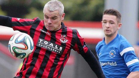 Gary McCutcheon of Crusaders in action against Liam Martin Of Ballinamallard