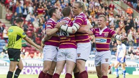 Huddersfield's Larne Patrick is congratulated on scoring against Widnes.