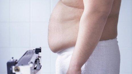 Obese man on weighing scales