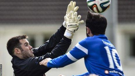 Glentoran keeper Chris Keenan challenges Johnny Lafferty for the high ball at Ferney Park