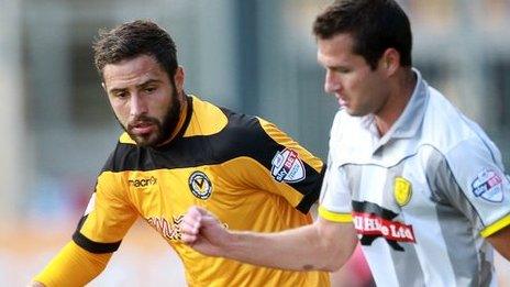 Robbie Willmott of Newport County is tackled by Phil Edwards of Burton Albion