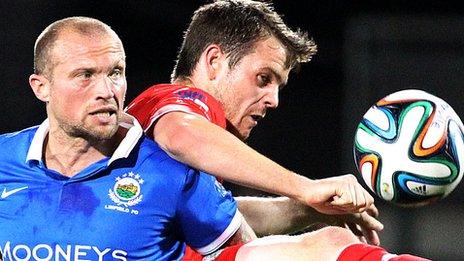 Linfield player-manager Warren Feeney battle against Jamie McGovern of Cliftonville