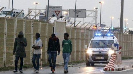 French police chase migrants out of a ferry terminal at Calais harbour (5 August 2014)