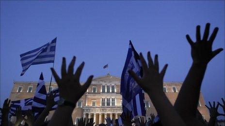 People outside the parliament building in Athens protest against any further budget cuts (19 June 2011)