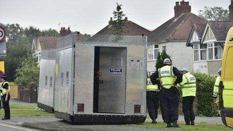 A mobile police cordon being pushed into place