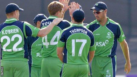 Craig Young is congratulated after taking one of his five wickets against Scotland