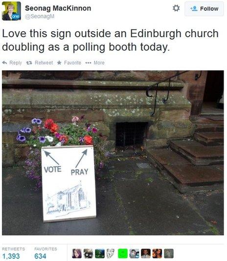 A sign reading 'vote' and 'pray' outside polling booth in a church