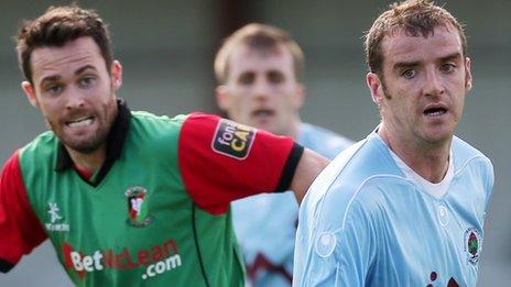 David Scullion of Glentoran and Aaron Walsh of Institute