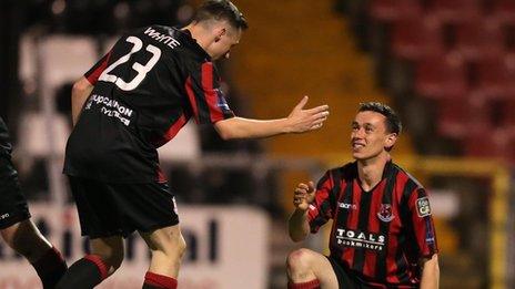 Gavin Whyte congratulates Crusaders goalscorer Paul Heatley