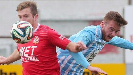 Portadown's Mark McAllister in action against Mark Hughes of Warrenpoint Town