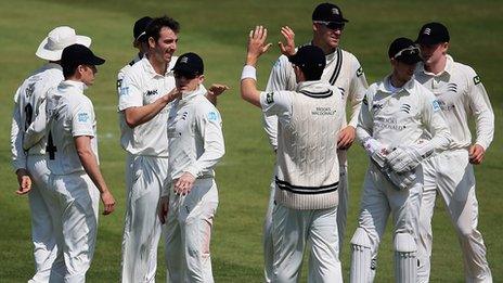 Middlesex bowler Tony Roland-Jones is congratulated by his teammates