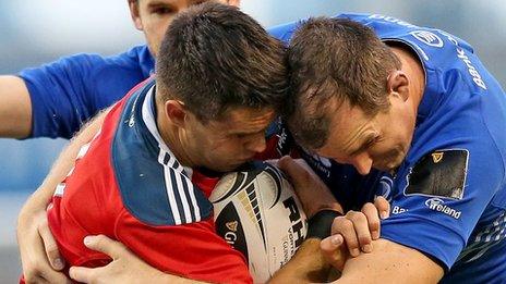 Munster's Conor Murray battles for the ball with Devin Toner of Leinster