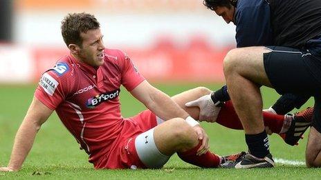 Gareth Davies receives treatment before leaving the field