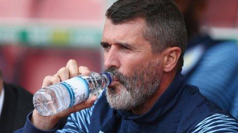 Roy Keane drinking from a water bottle