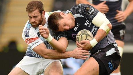 Dan Biggar of Ospreys is tackled by Geraint Walsh of Cardiff Blues