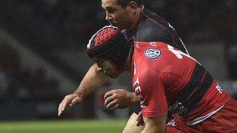 Leigh Halfpenny battles for the ball with Toulouse scrum-half Jean-Marc Doussain during his Toulon debut