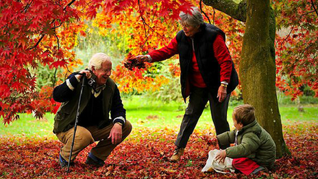 Two retirees with grandchild