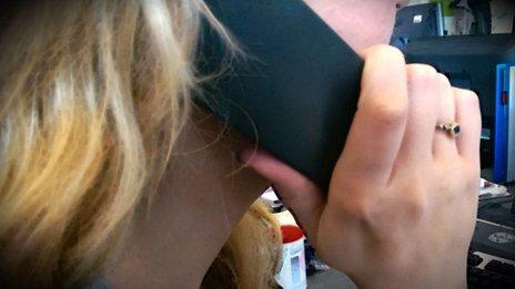 woman holding a telephone