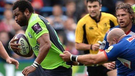 Manoa Vosawai of Cardiff Blues is tackled by Remy Hugues of Grenoble