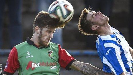 Glentoran's Stephen McCullough beats Ian Parkhill to the high ball at the Showgrounds