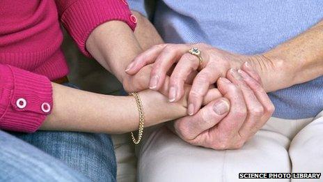 Elderly woman being comforted by a carer