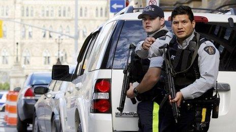 Armed RCMP officers guard access to Parliament Hill in Ottawa