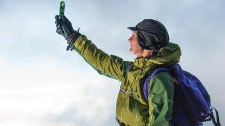 Checking weather conditions on top of Helvellyn