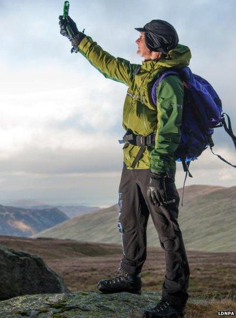 Checking weather conditions on top of Helvellyn