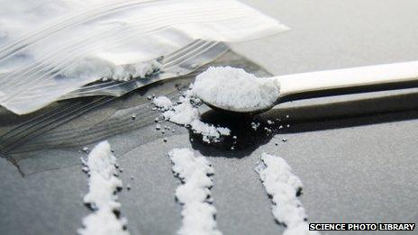 A spoon and a bag with white powder - cocaine