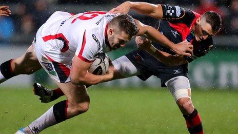 Ulster centre Stuart McCloskey is tackled by Dragons opponent Jason Tovey