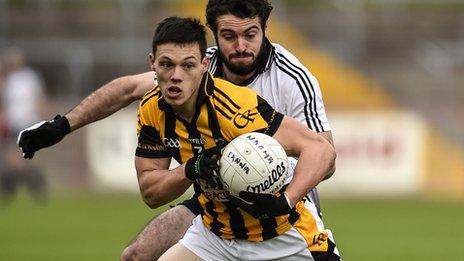 Crossmaglen's James Morgan comes under pressure from Jason McAnulla of Omagh