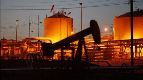 Oil rig in front of refinery