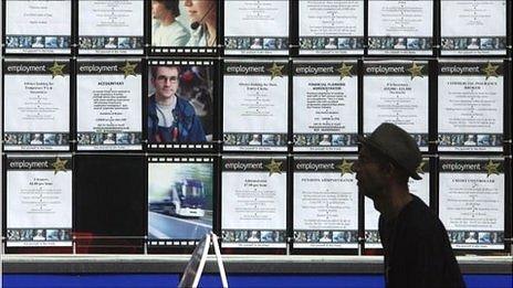 Man walks past vacancies signs at a recruitment office in Bristol