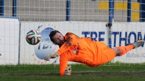 Dungannon keeper Andy Coleman saves Neil McCafferty's corner