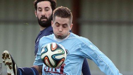 Ballinamallard forward Johnny Laffert puts pressure on Institute's Robbie Hume