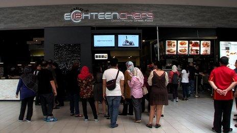 A line of people outside Eighteen Chefs