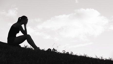 Unhappy teenage girl in silhouette