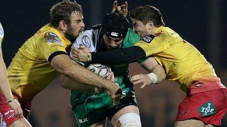 Scarlets pair Steffan Evans and Johan Snyman tackle Connacht's John Muldoon