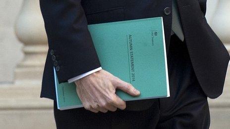 George Osborne, holding a copy of the Autumn Statement as hea leaves Treasury in London