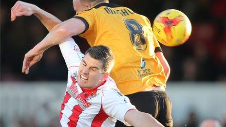 Newport County's Lee Minshull challenges Stevenage's David McAllister