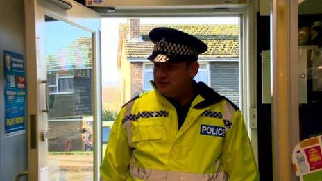 Police officer entering a shop in Colsterworth