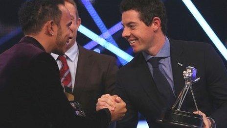 Winner of Sports Personality of the Year 2014, Lewis Hamilton shakes hands with second placed Rory McIlroy